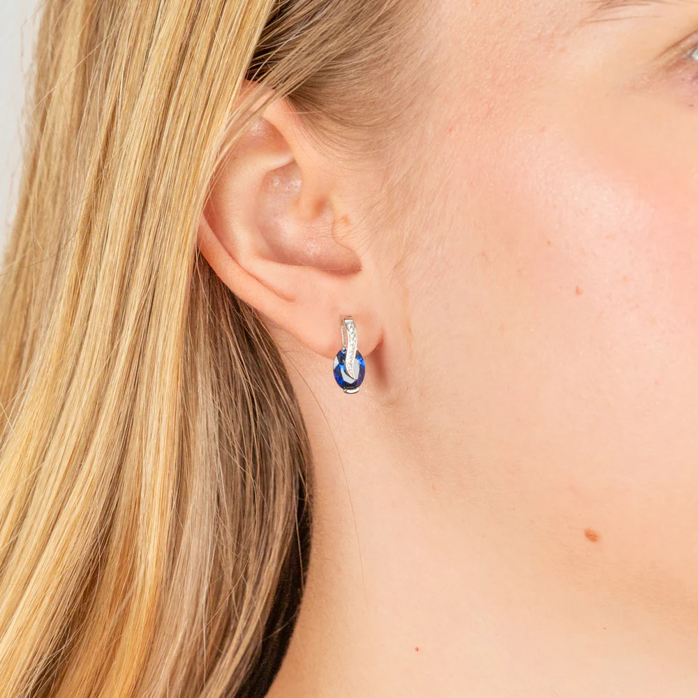 Sterling Silver Rhodium Plated Blue And White Cubic Zirconia Crossove Stud Earrings - Image 2